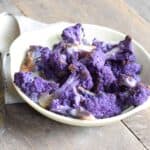 Roasted Purple Cauliflower in a white bowl