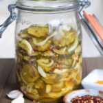 sweet and hot pickles with onions crushed red pepper in a jar