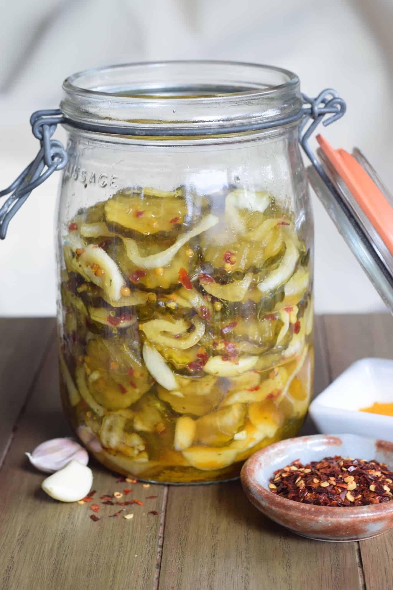 sweet and hot pickles with onions crushed red pepper in a jar