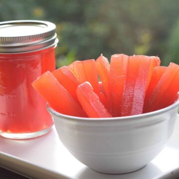Cinnamon Candy Christmas Pickles are a vibrant red color. I made them in sticks from large cucumbers and cinnamon red hot candies.