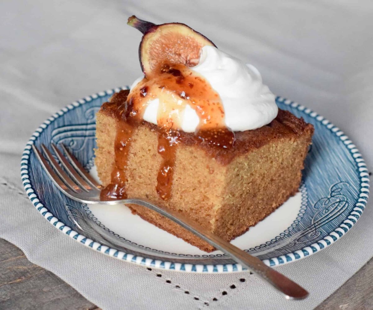 Fig Jam Cake with whipped cream, fig half and Fig and Lemon Preserves drizzled.