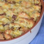 bacon sausage strata baked in stoneware dish on blue placemat