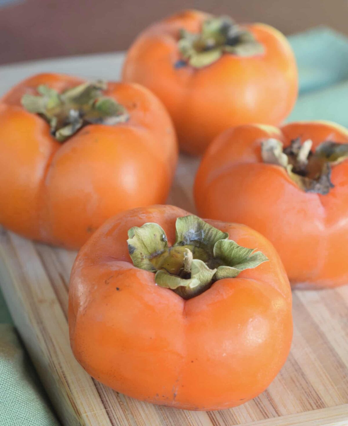 Four Fuyu persimmons close up