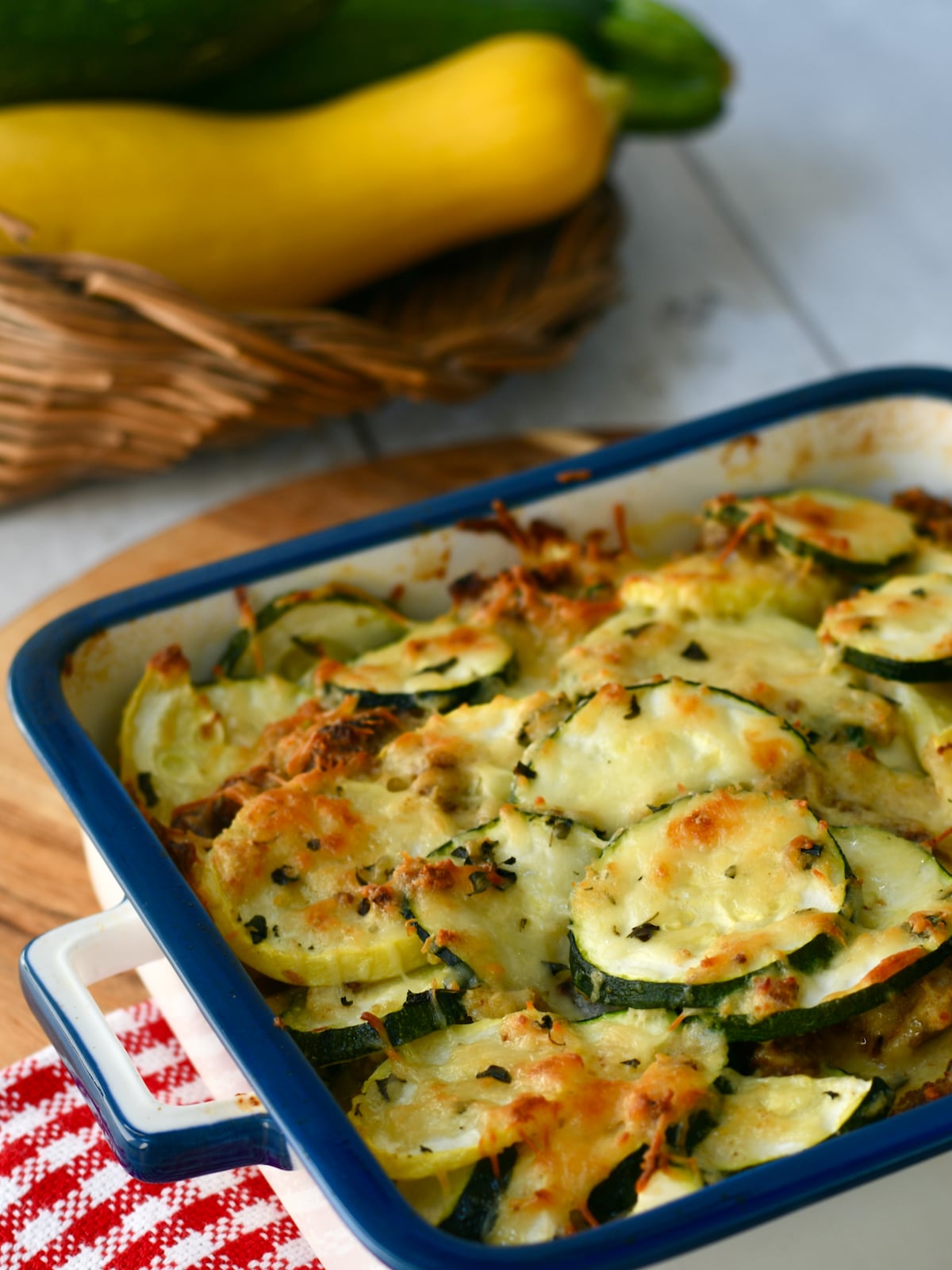 Zucchini Squash Casserole with Yellow squash in square dish.