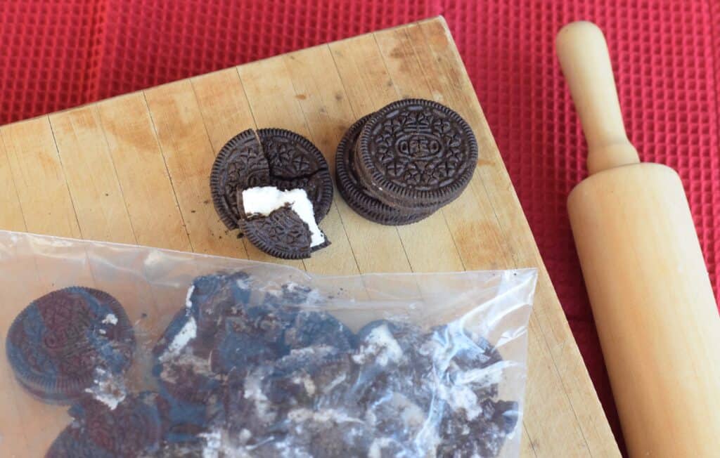 Process shot 1. Crush Oreo cookies with a rolling pin in a zip top bag