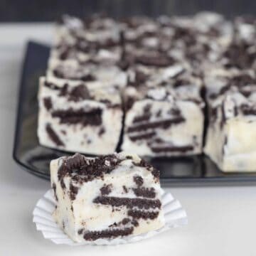 Cookies n Cream White Chocolate Fudge cut into squares revealing the yummy crushed Oreo cookies