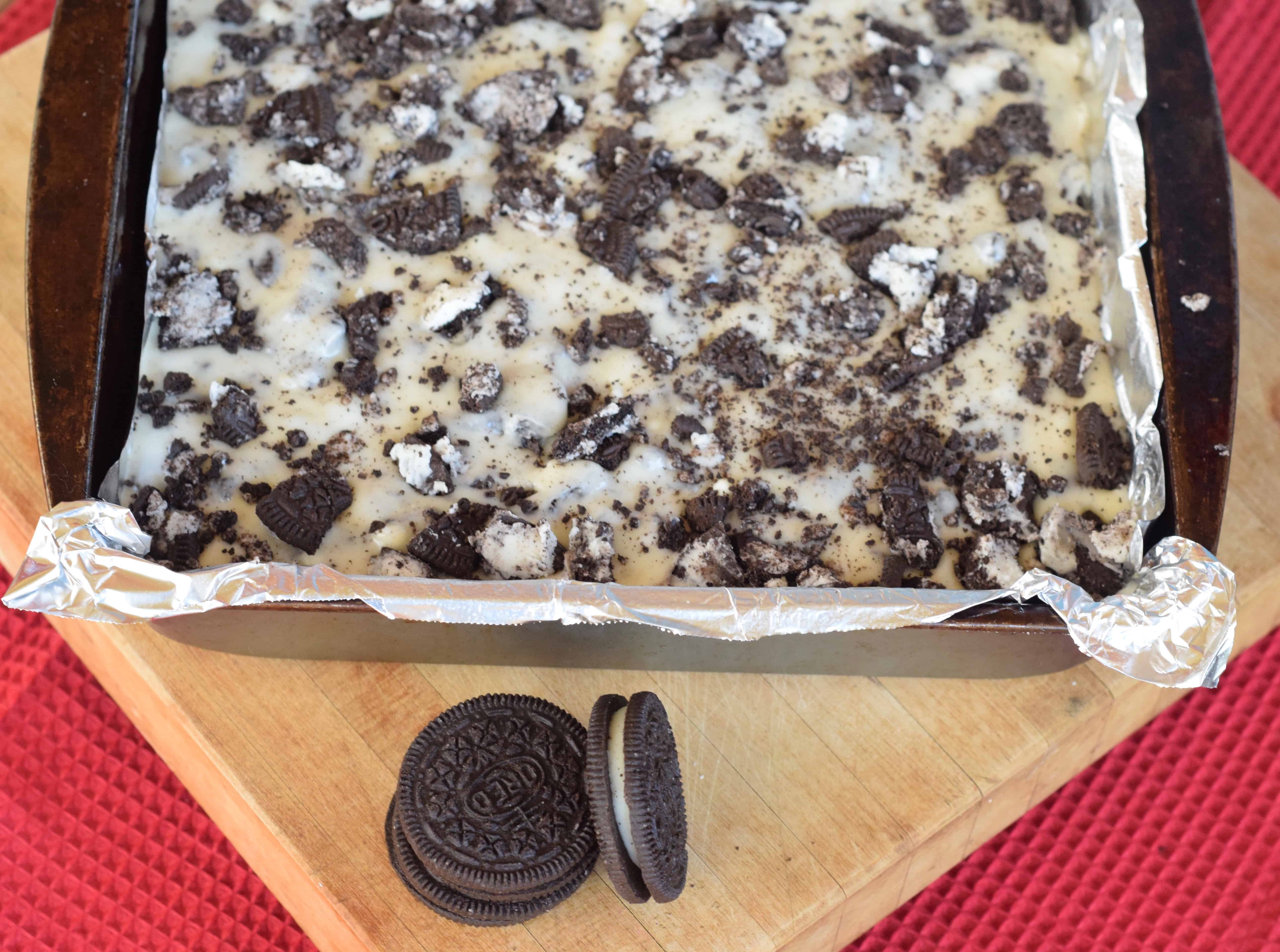Cookies n Cream White Chocolate Fudge in a square pan lined with foil for easy clean up