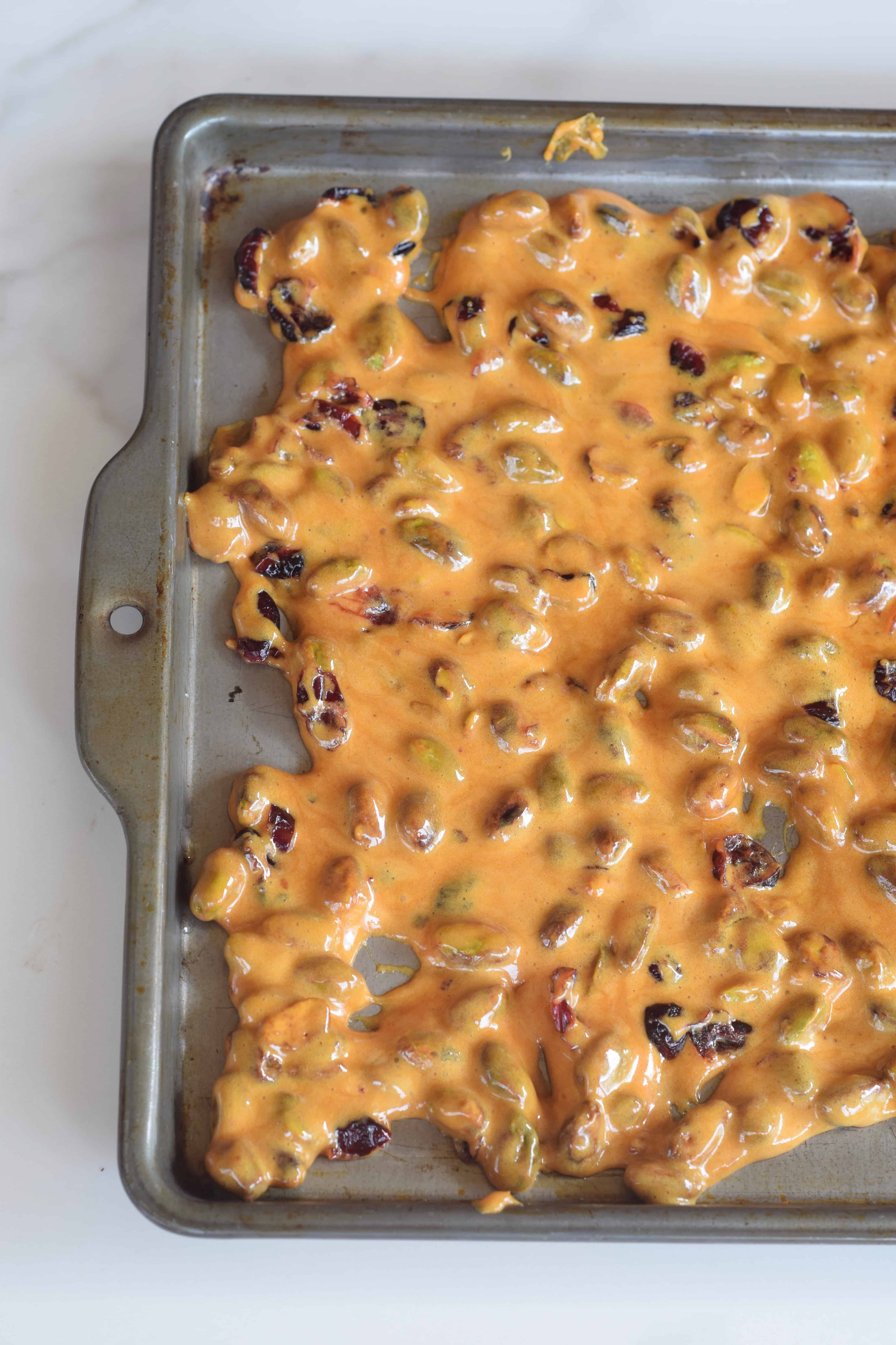 Cranberry Pistachio Brittle immediately poured onto a buttered baking sheet to cool.