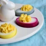 Close up of deviled eggs that are dyed different colors.