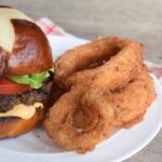 Vidalia onion rings venison burger pretzel bun