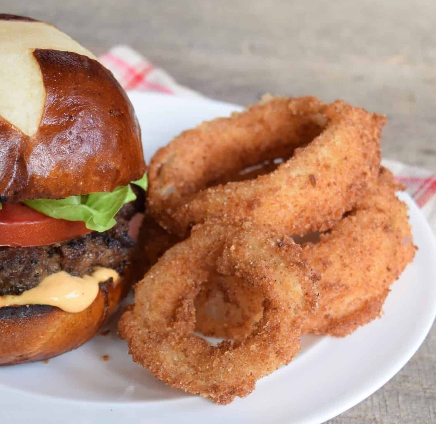 Vidalia onion rings venison burger pretzel bun