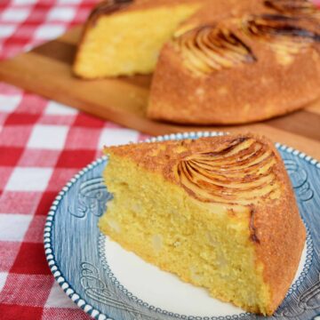 vidalia onion cornbread wedge on blue plate with cornbread in background on wooden cutting board