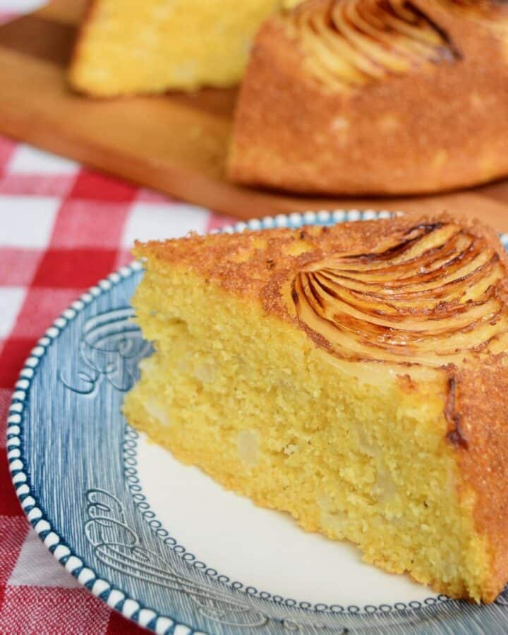 vidalia onion cornbread wedge on blue plate with cornbread in background on wooden cutting board