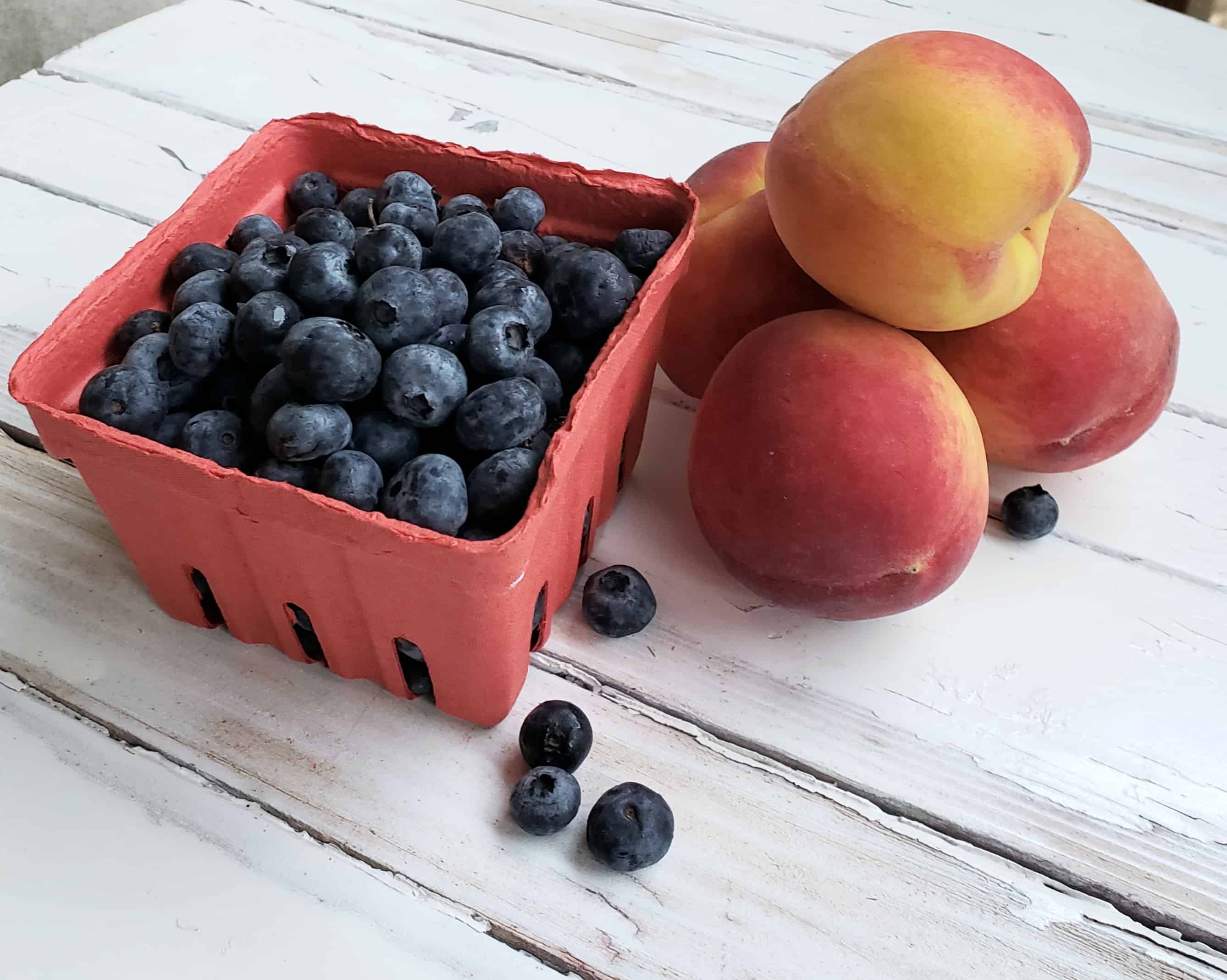 Blueberries and Peaches on white table