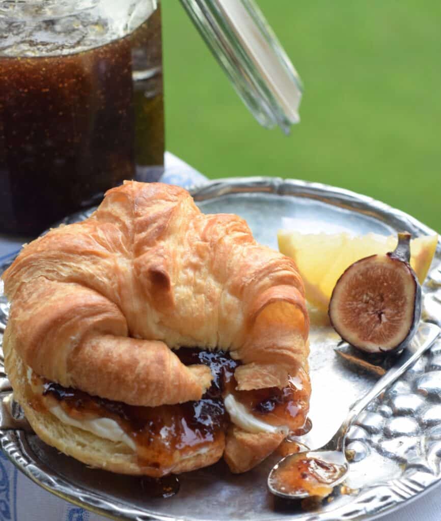 Fig and Lemon preserves on a bagel with cream cheese and jar of preserves in background