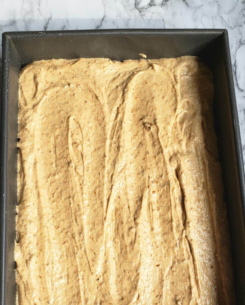 Fig jam cake batter spread in a baking pan