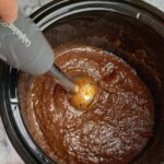 Immersion Blender in slow cooker crock of fig jam