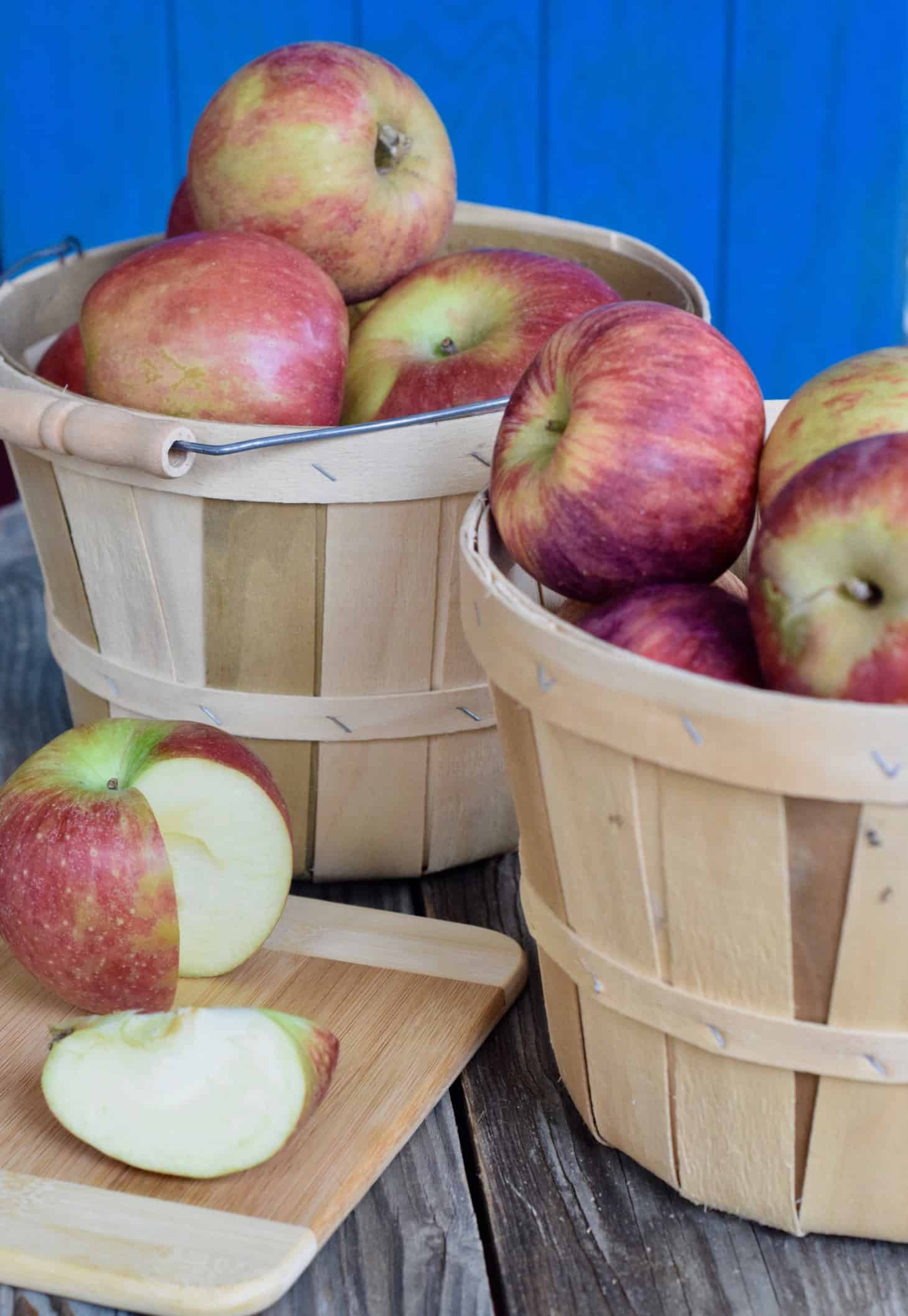 Apples in bushel basket with 1 sliced open