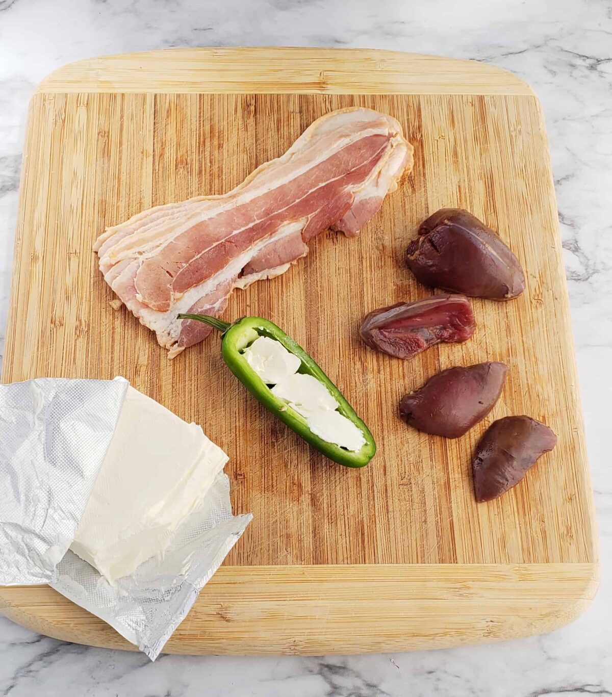 bacon cream cheese jalapeno on a cutting board