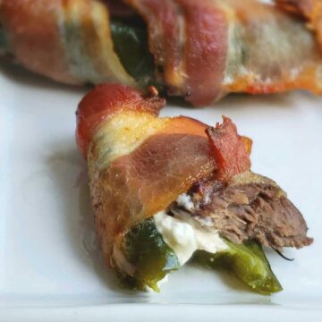 Close up Bacon Wrapped Dove Jalapeno poppers on a white platter Thanksgiving
