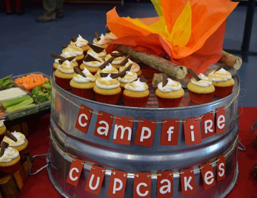 smores cupcakes on a metal tub with words Campfire Cupcakes strung across