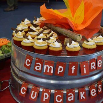 smores cupcakes on a metal tub with words Campfire Cupcakes strung across
