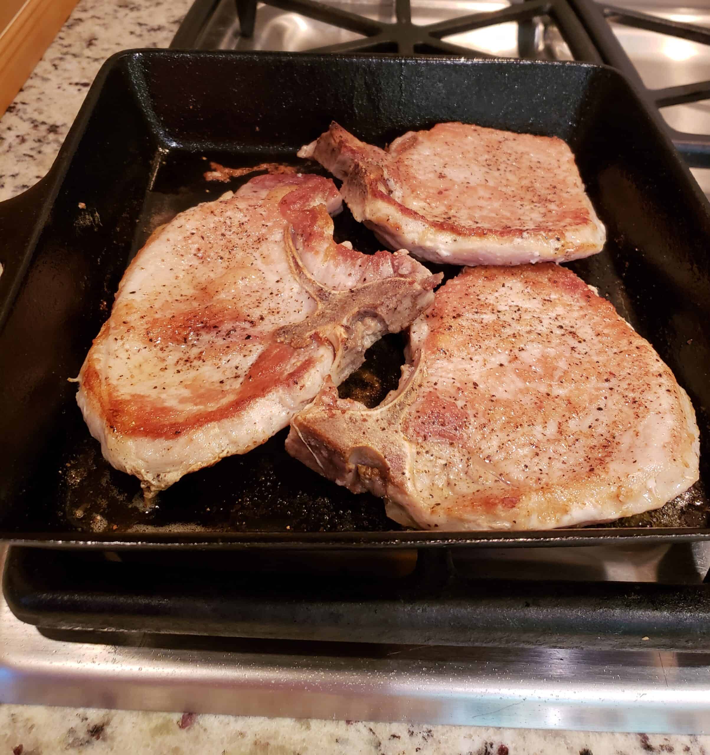 Pan Seared Pork Chops browned in skillet