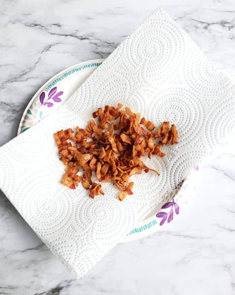 Drain the chopped cooked bacon on paper towels.