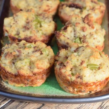 Individual size sausage cornbread dressings baked in a muffin pan and served on a green platter Pinterest Pin