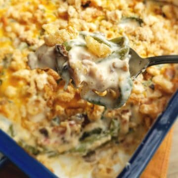 Keto and Gluten Free Green Bean casserole being scooped out of the dish and focus is on the spoonful