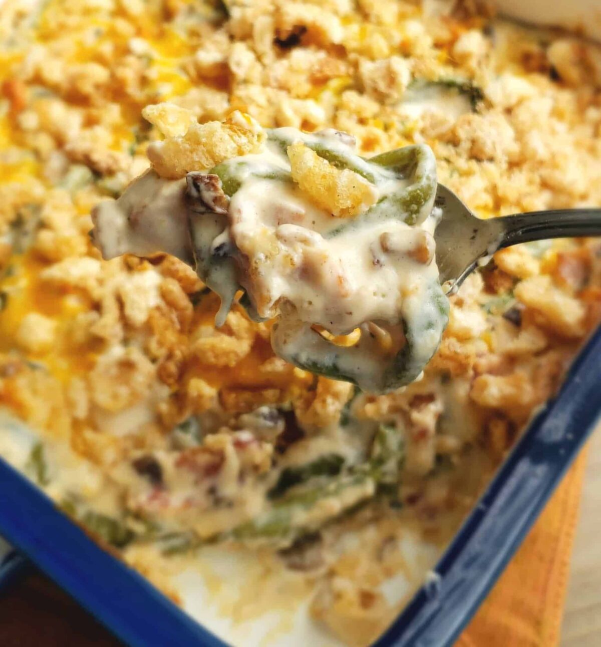 Keto and Gluten Free Green Bean casserole being scooped out of the dish and focus is on the spoonful