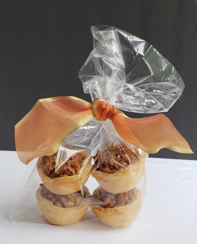 These bite-size pecan pies are made with a hint of maple syrup. The pie crust is a Southern shortcut to your holiday table! Perfect for gift giving.