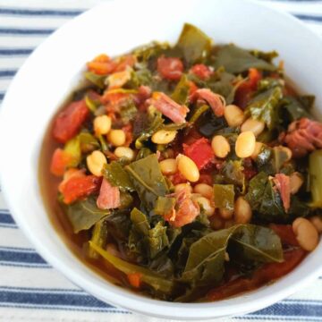 Collard Greens and Navy Beans are cooked in a fraction of the typical time when cooked in the Instant Pot. Served in a white bowl on a blue and white striped placemat