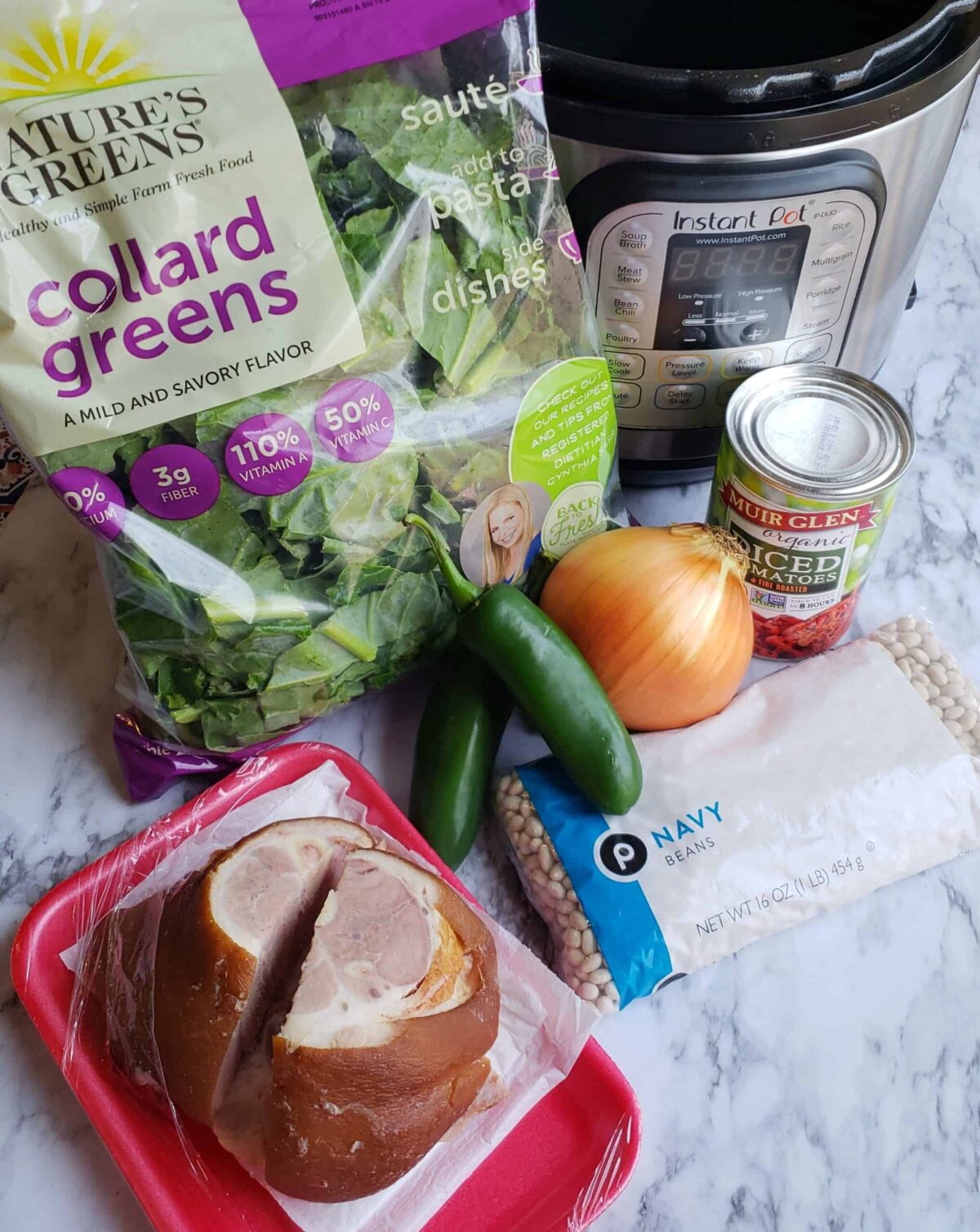 Ingredients for Instant Pot Collard Greens and Beans: Bag of collard greens, can of tomatoes, ham hock, jalapeno peppers, onion, dried Navy beans