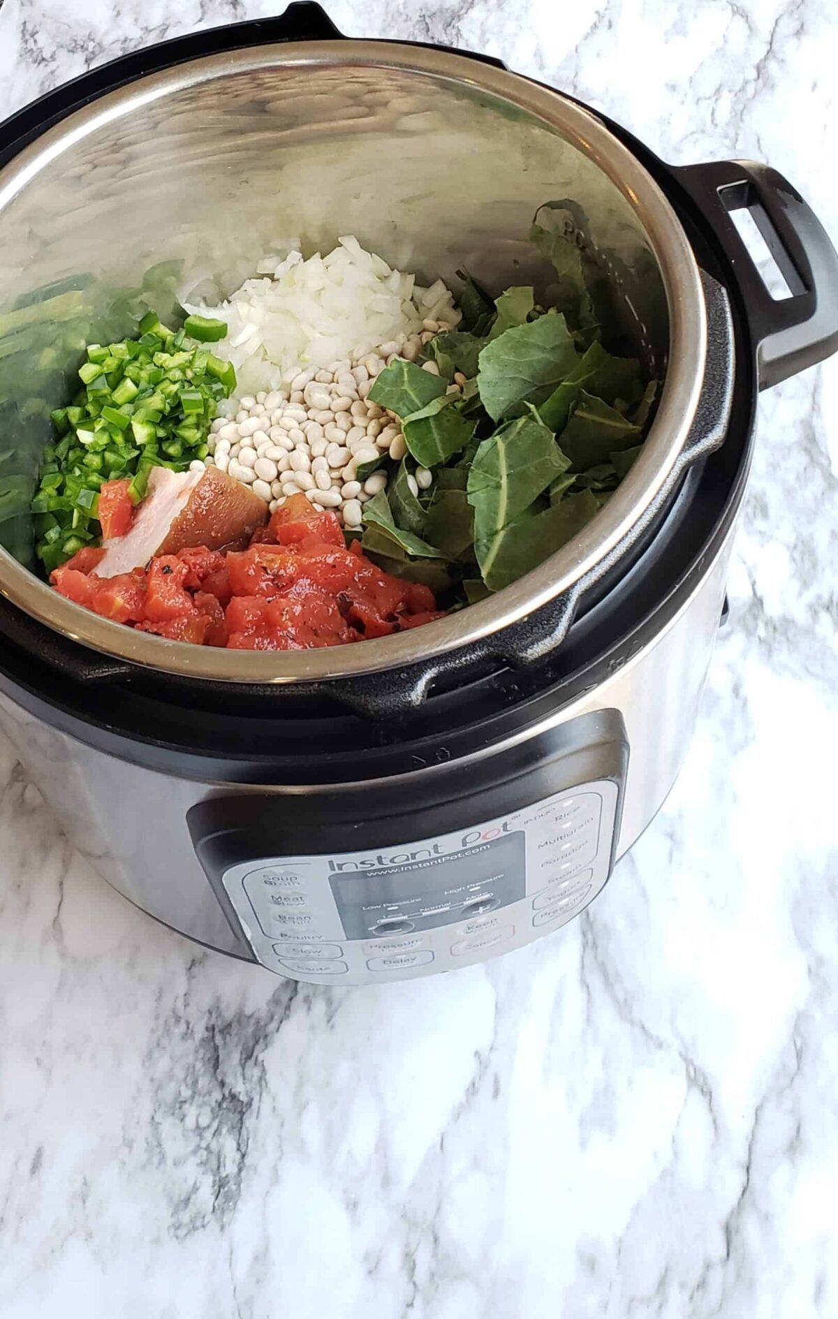 Fresh ingredients like pre-washed collard greens, jalapeno peppers, onion, and tomatoes are cooked right along with dried (unsoaked) Navy beans for Instant Pot Collard Greens and Navy Beans recipe. they all fit in this 6 quart Instant Pot