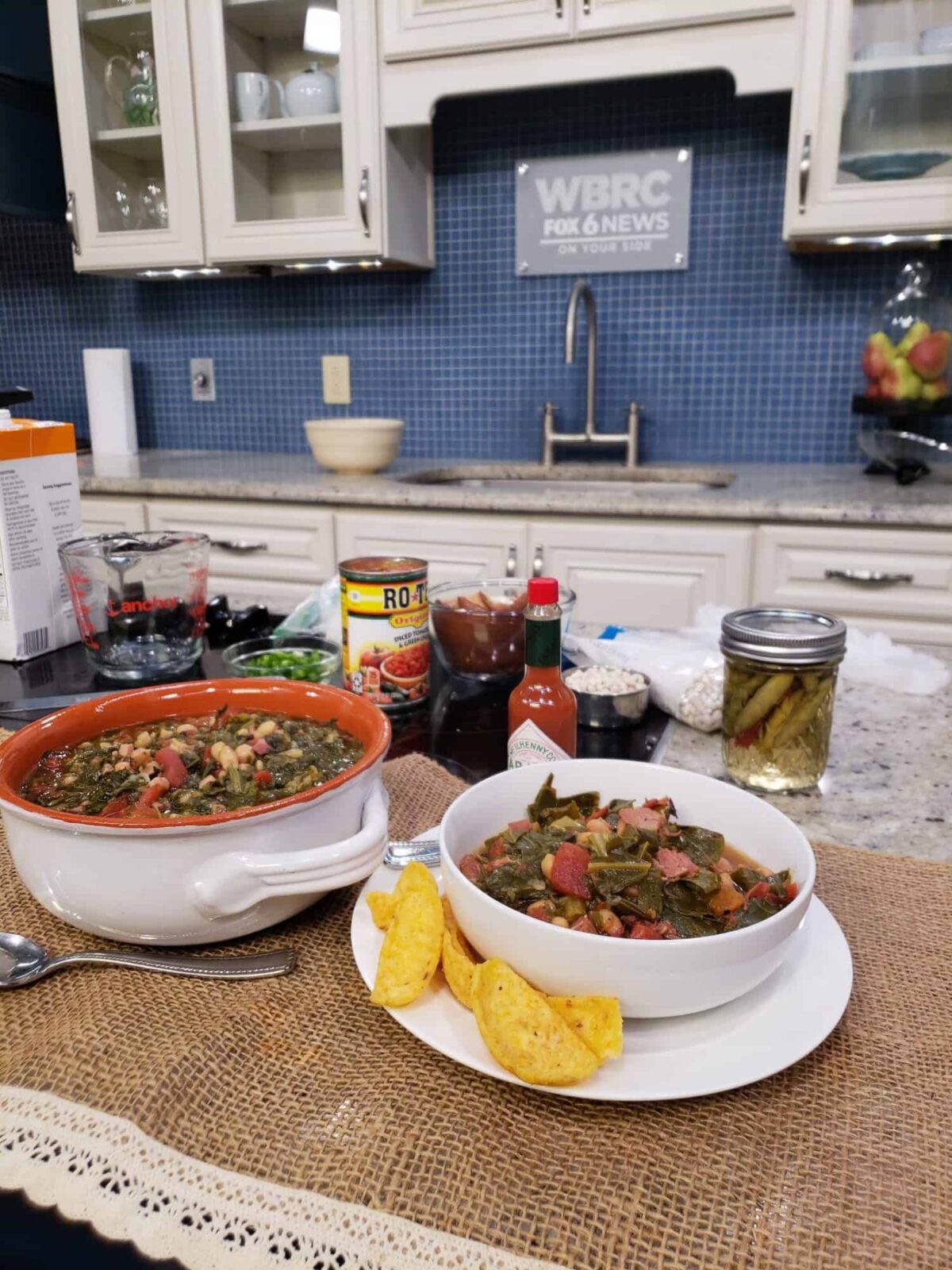 Good Day Alabama tv kitchen with collard greens and tomatoes in bowls on burlap fabric