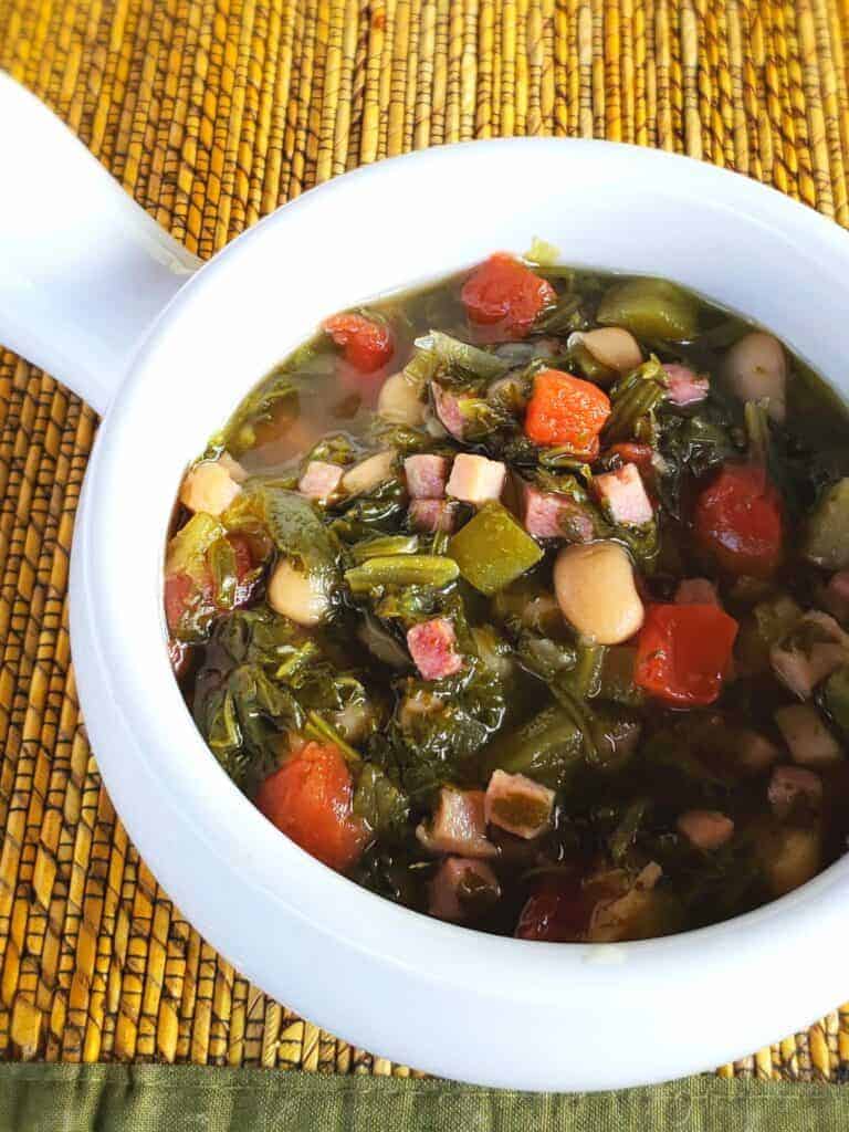 We Southerners love our greens-turnip greens. This dump and stir soup gets you in and out of the kitchen but tastes like you cooked them low and slow all day. Served in a white bowl.