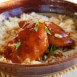 Instant Pot Teriyaki Chicken Thighs is so easy, impressive and yummy! Served over rice in a pottery bowl and garnish with green onions