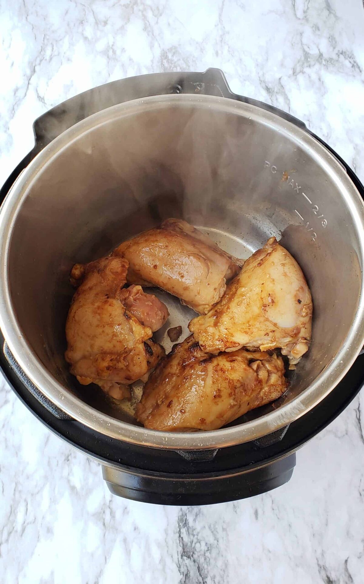 Brown the marinated chicken thighs in the Instant Pot on Sautee setting
