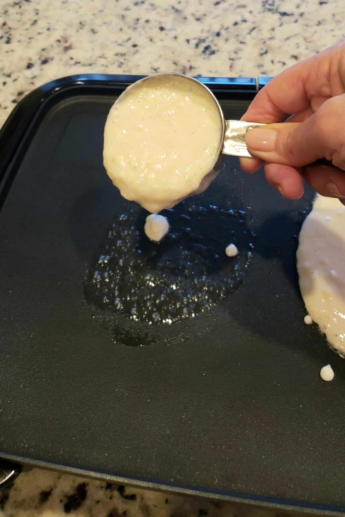 Pouring the pancake batter onto the griddle with a dry measuring cup is a great way to avoid dragging a spoon back and forth. That gets messy. This method makes sure they come out perfectly round-or closer to it!