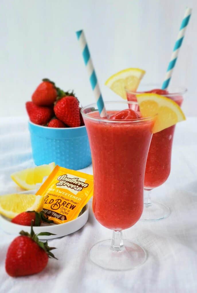 strawberry frozen lemonade with blue bowl of strawberries