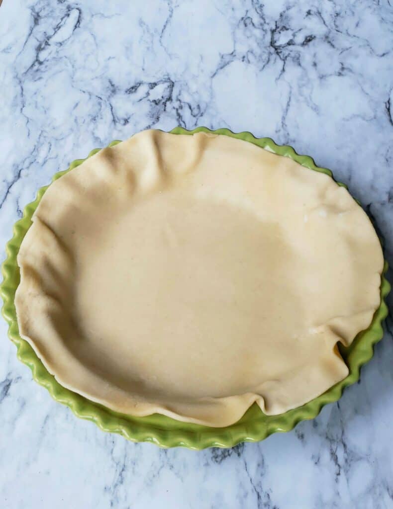 Fit the refrigerated pie crust into the bottom of a 9-inch pie plate. Don't press the crust too firmly or it will stick. Don't stretch and pull it either. Place it in the refrigerator while you combine the filling.