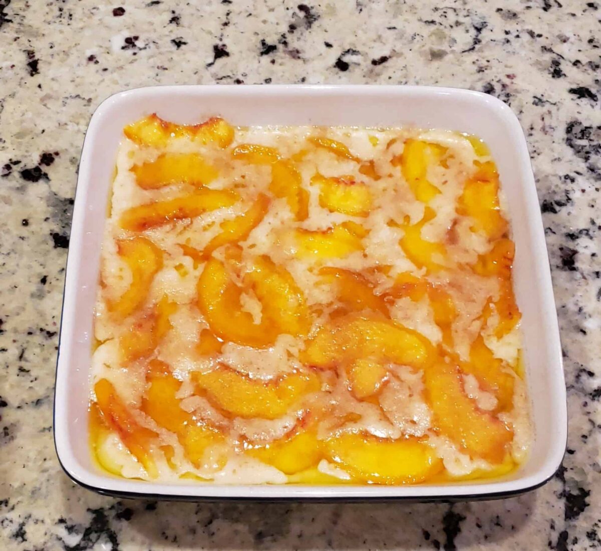 thin batter over the melted butter over nectarines in casserole 