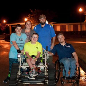 In 2018 Outdoor Ability Foundation presented brothers with spina bifida an Action Track Chair. Seen here with parents and Grayson Phillips.