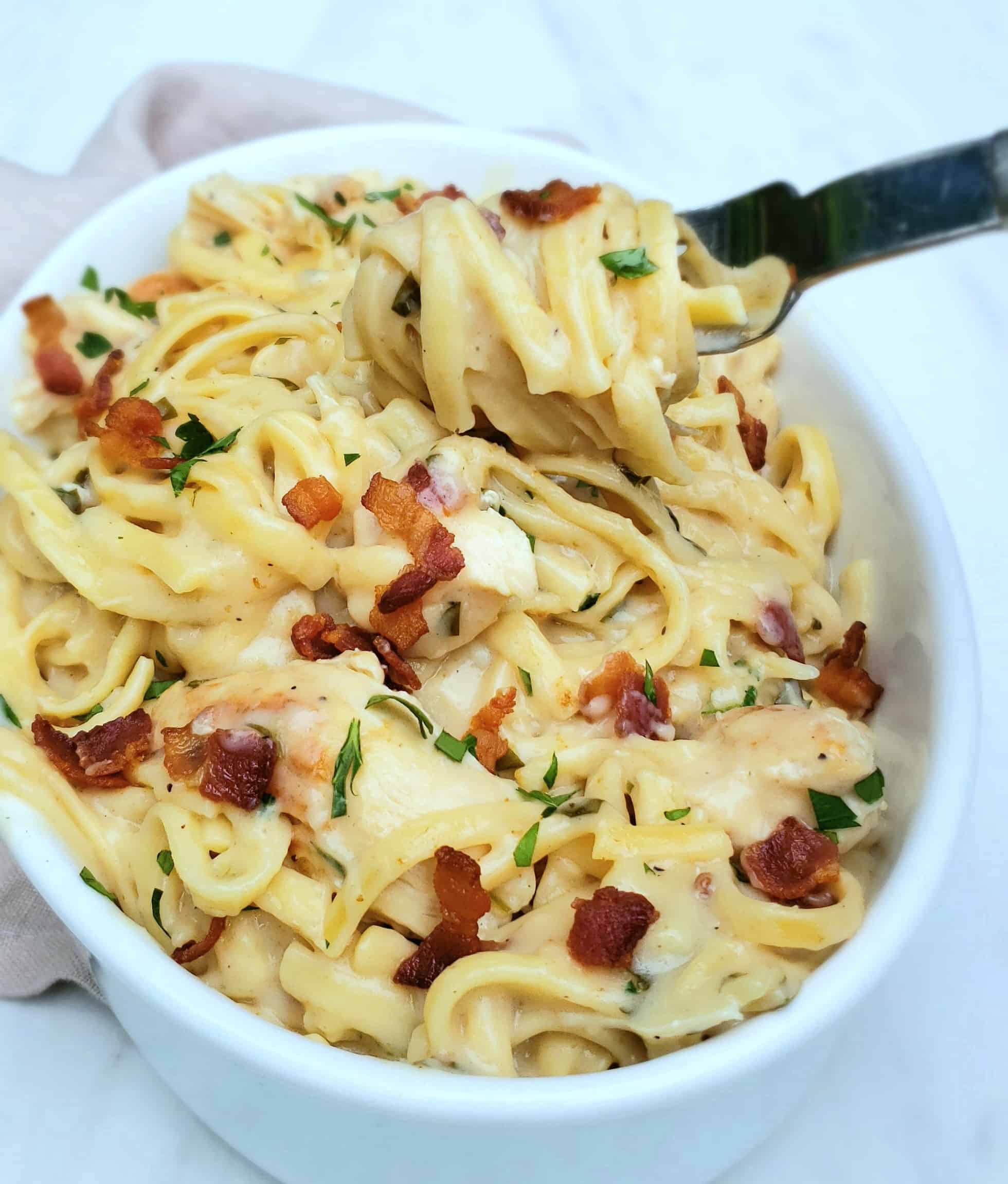 Chicken Bacon Ranch Alfredo made in the Instant Pot! Here in a white casserole dish