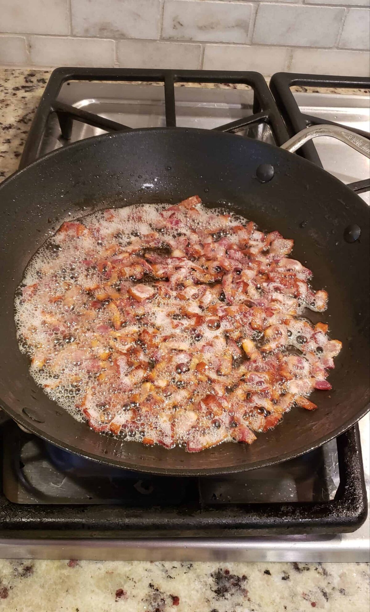 Frying cut up bacon in skillet