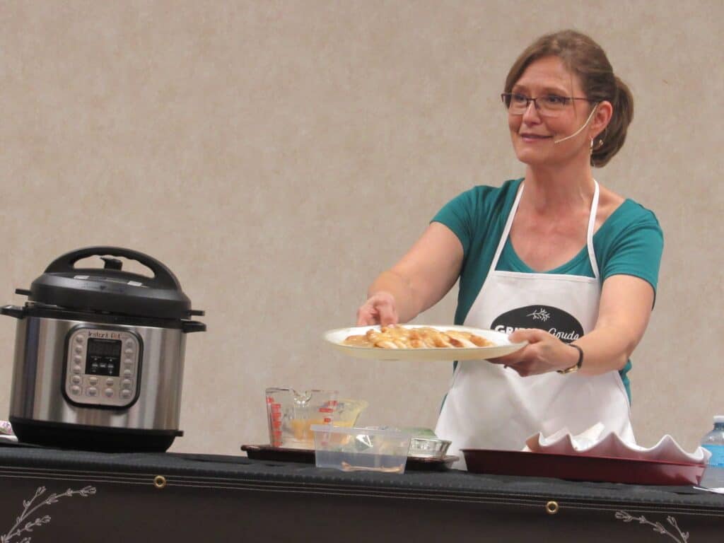 woman holding out tray of sliced turkey