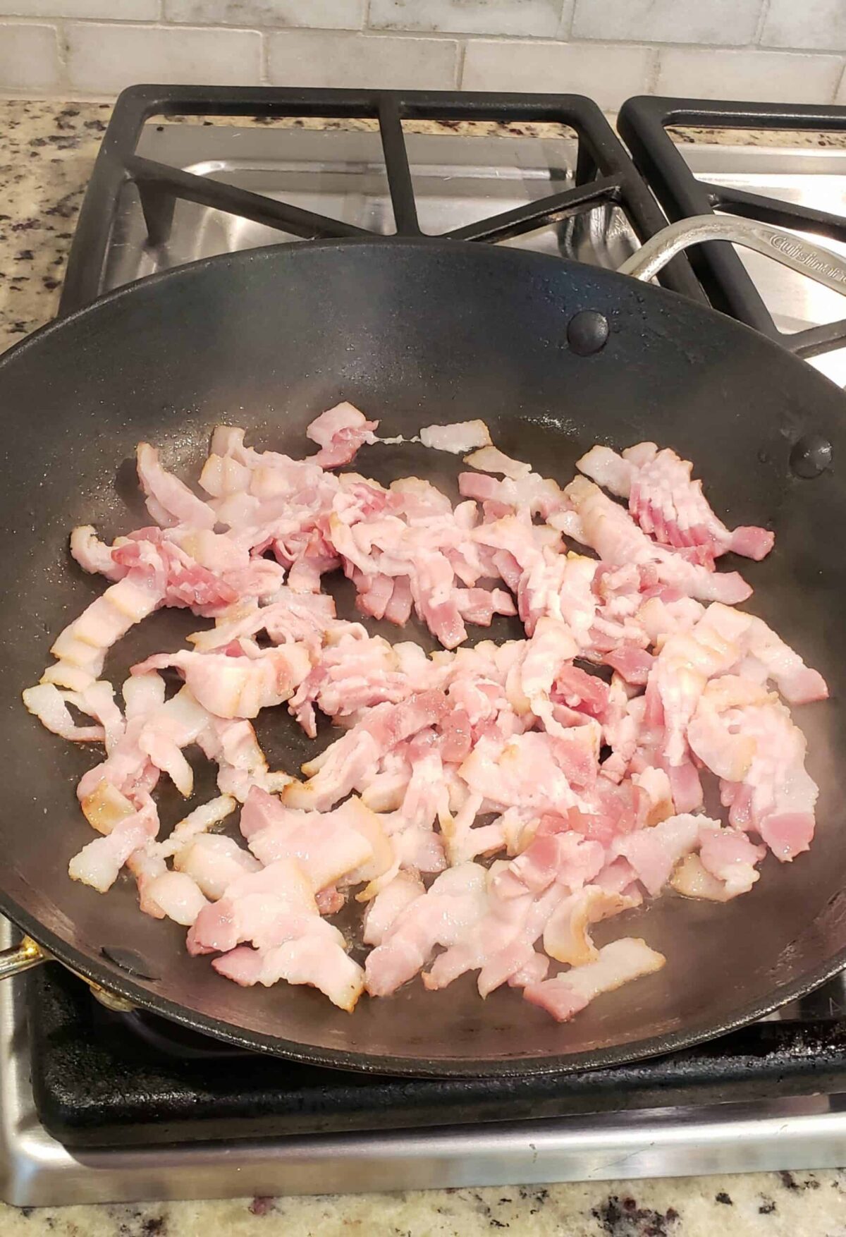 Raw bacon pieces in skillet before frying