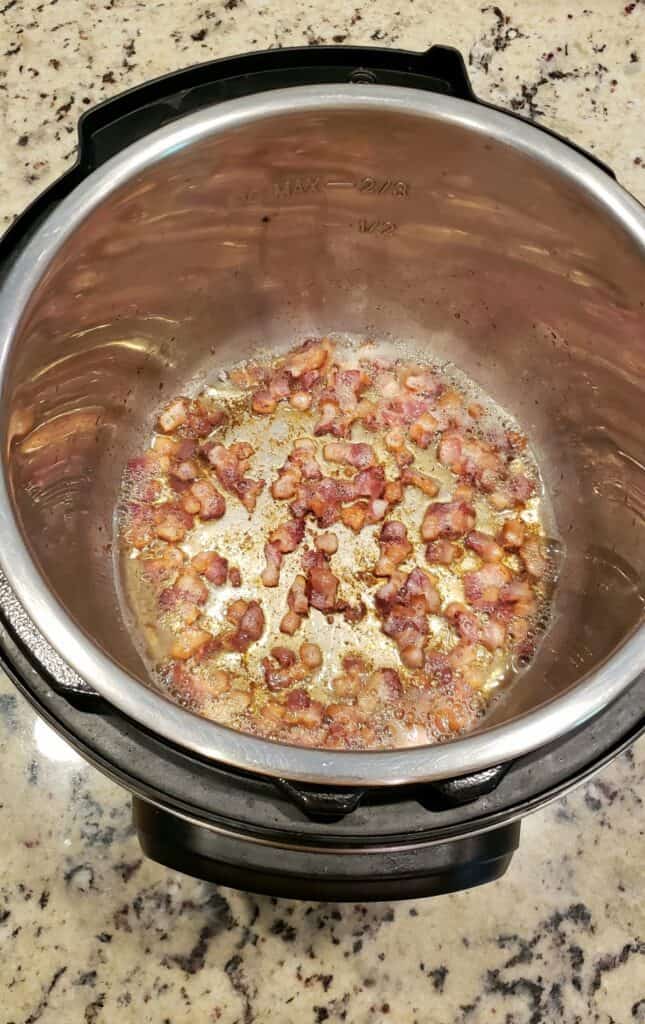 Cooked bacon pieces in an Instant Pot overhead view.