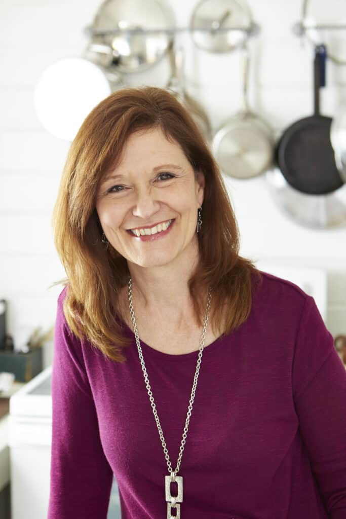 Kathleen Royal Phillips, author of food blog GritsAndGouda.com with pots behind her